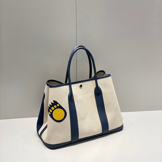 HERMES GARDEN PARTY 36 IN NAVY CREAM TOILE H CANVAS BLUE MARINE CALFSKIN ABSTRACT BEAR FACE PRINT